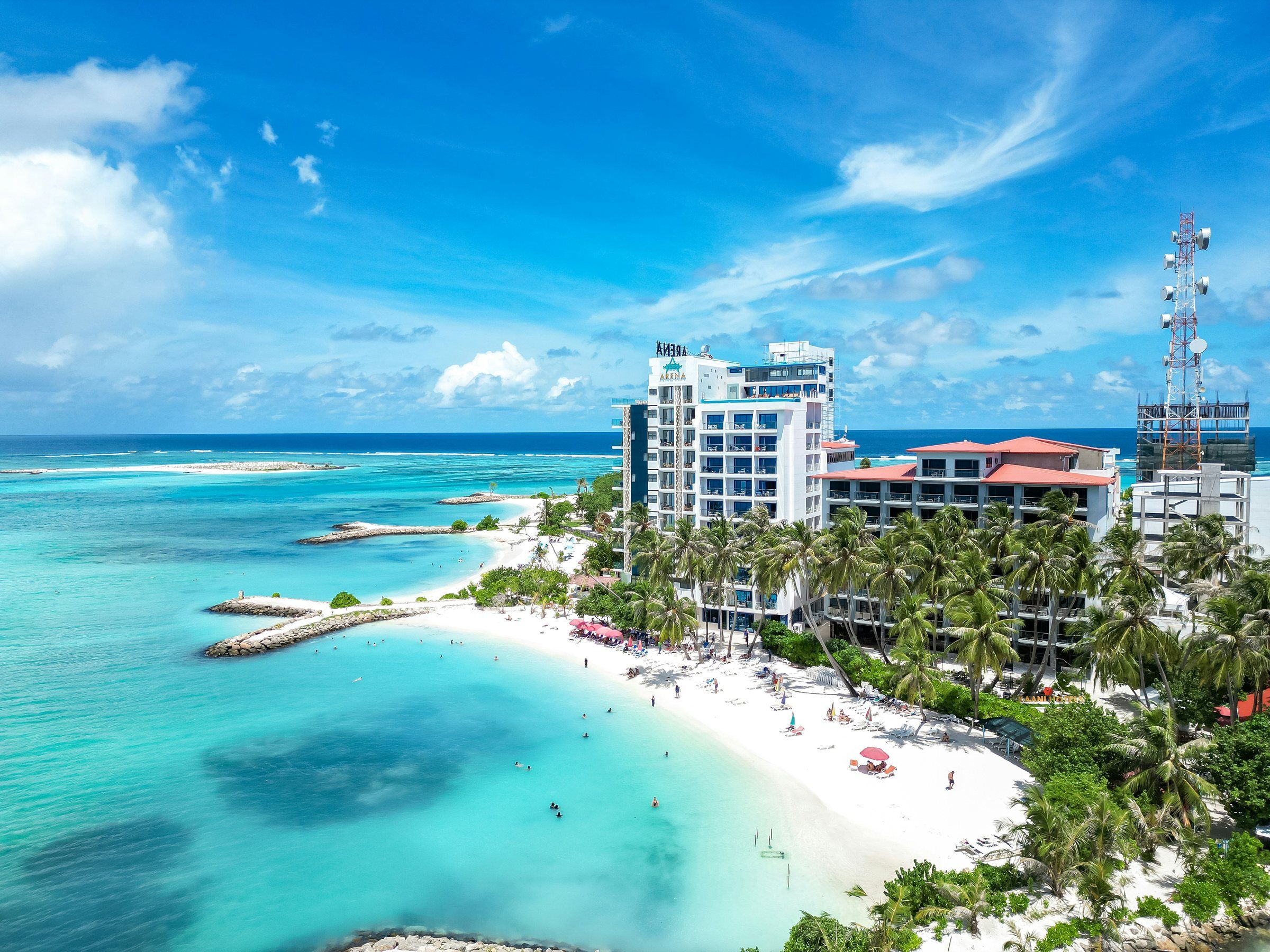 Aerial view of Maafushi's tourist beach with guesthouses lined up behind it